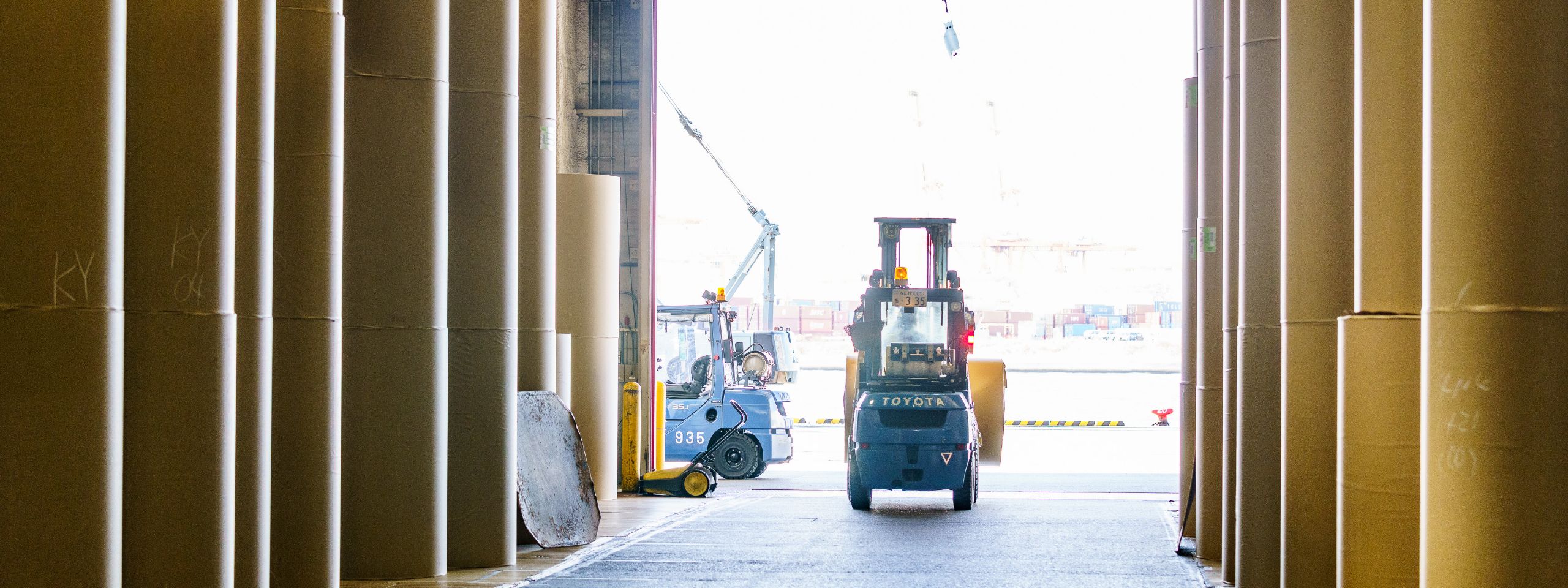 倉庫内でフォークリフトがパレットを運搬している様子